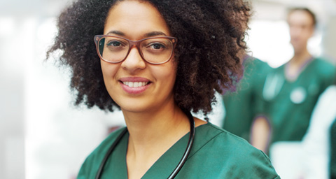 African American nurse in green scrubs.